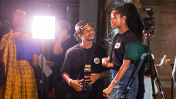 Two young people with camera equipment talking